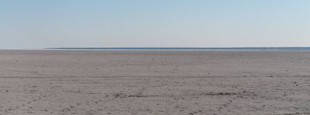 An overview of the empty space of the Etosha salt pan, Ethosha National Park, Namibia.の写真素材