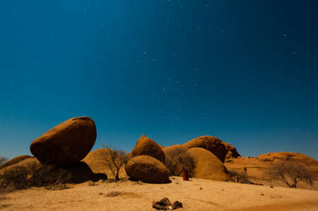 Night shot in the Namibian Desert showing the stars coming out.の写真素材