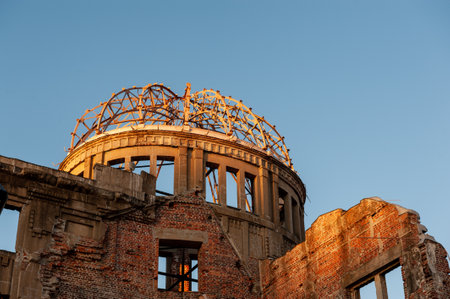 The last rays of the setting sun reflect upon the canopy of the Atomic Bomb dome in Hiroshima,...