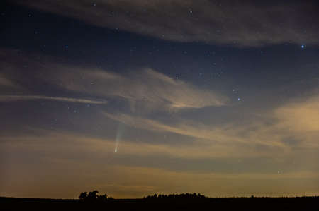 Night time landscape shot of rural belgium with comet NEOWISE prominently in the sky.の写真素材