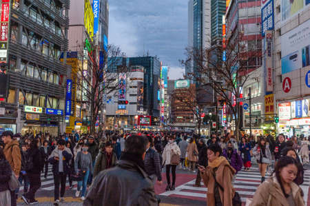 Tokyo, Japan - January 8, 2020. Many people walking along the busy streets and crossing at the...