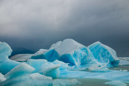 A field of ice on Lago Argentina, contrasted with an overcast sky.