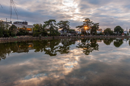 Nara, Japan - January 5, 2020. Exterior sunset shot from Sarusawa Pond Park in Nara. Nara is a historic city in Japan, famous for its many temples and Shrines. Many people visit during the first days of the new year.のeditorial素材