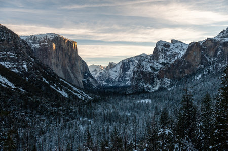 Wide-angle shot of Yosemite valley from tunnel view on an early winter morning. El capitan catches the first rays of sunlight of the new year.の写真素材