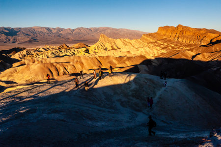 December 26, 2021 - Spectators observing an early morning sunrise at Zabriskie Point, Death Valley.のeditorial素材