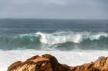 Spectacularly big waves from the pacific ocean smash into the californian coast along US highway 1.の写真素材