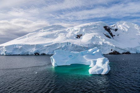 A tranquil Antarctic landscape, near Graham passage along Charlotte Bay, highlighting stark...