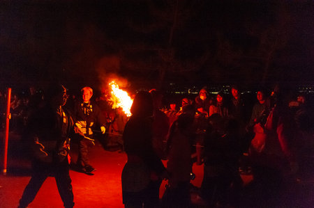 Miyajima, Japan - December 31, 2019. Participants of the Chinkasai Fire Festival at Itsukushima Shrine, near Hiroshima, carry large burning torches around the sea shore as part of a ritual to safeguard the island from fires.のeditorial素材