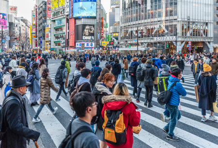 Tokyo, Japan - January 8, 2020. Many people walking along the busy streets and crossing at the famous Shibuya Crossing just around sunset. Shibuya is one of the most famous intersections in Tokyo.のeditorial素材