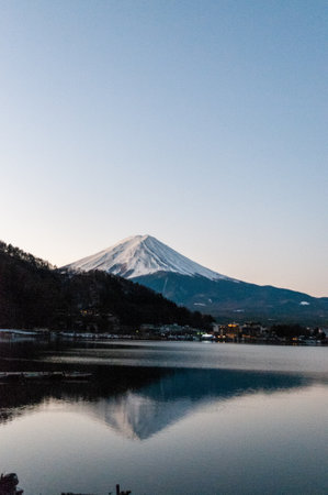 Mount Fuji on a bright winter morning, as seen from across lake Kawaguchi, and the nearby town of Kawaguchiko.の写真素材