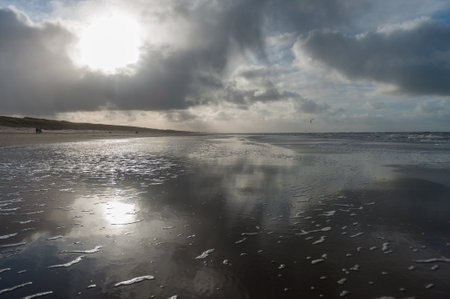 Clouds reflecting in a residu of water on the Beach near Egmond aan Zeen in North Holland, the Netherlands.の写真素材