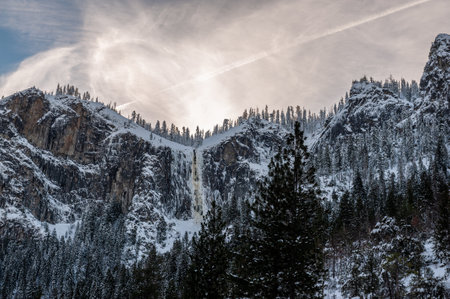 Looking straight up to the partially frozen upper yosemite falls from the valley floor. Yosemite...