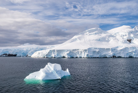 A tranquil Antarctic landscape, near Graham passage along Charlotte Bay, highlighting stark...