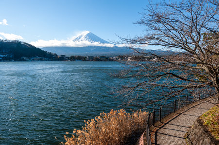 Mount Fuji on a bright winter morning, as seen from across lake Kawaguchi, and the nearby town of Kawaguchiko.の写真素材