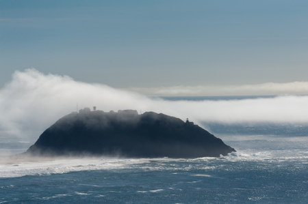 A layer of fog is rolling out over Point Sur, California.の写真素材