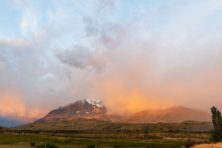 Early morning sunrise over Torres Del Paine national park in Patagonia, Chile, highlighting dramatic colours and a rainbow.の写真素材
