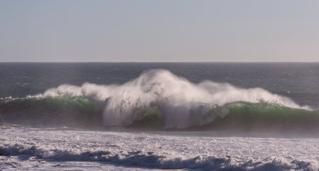 Spectacularly big waves from the pacific ocean smash into the californian coast along US highway 1.の写真素材