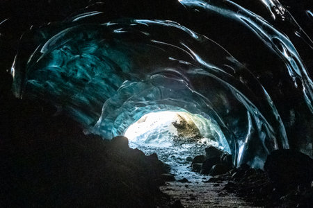 Bright blue colours resulting from light passing through a layer of ice inside the Blue Ice cave near the Jokulsarlon ice lagoon in southern Icelandの写真素材