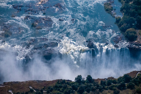 Telephoto shot of the immense Victoria falls, as seen from the air.の写真素材