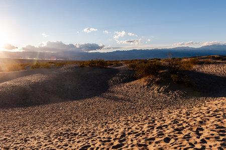 Sunset near the flat sand dunes in Death Valley National Park, California.の写真素材