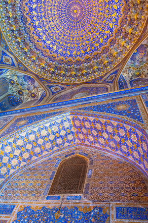 Detail of the stunningly beautiful interior mozaics of the Tilya-Kori Mosque in historic Samarkandの写真素材