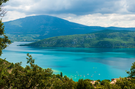 Overlooking lac de Sainte-Croix, a beautiful mountain lake in the French provence, from the town of Aiguines.の写真素材