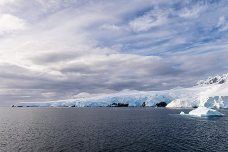 A tranquil Antarctic landscape, near Graham passage along Charlotte Bay, highlighting stark...