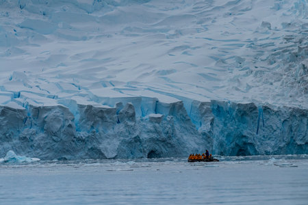 Danco Island, Antarctic Peninsula - January 31, 2024. A group of Antarctic tourists is cruising around the icebergs near Danco Island.のeditorial素材