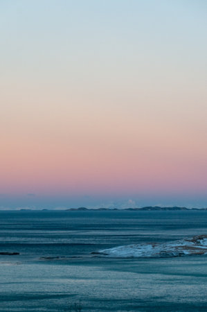 Overlooking the snow-covered beaches of arctic norway, near the town of Bodo, during the golden hour...