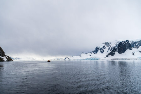 Cuverville Island, Antarctic Peninsula - January 31, 2024. Antarctic tourists explore ocean near Cuverville Island using a zodiac, in the Antarctic Peninsulaのeditorial素材