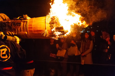 Miyajima, Japan - December 31, 2019. Participants of the Chinkasai Fire Festival at Itsukushima...