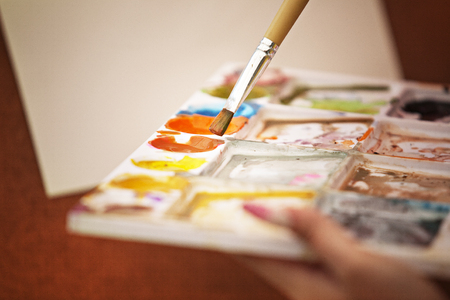 artist paints on paper with oil colorsの写真素材