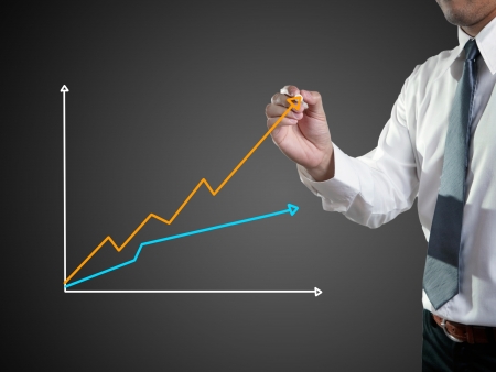 Business man hand drawing a graph の写真素材