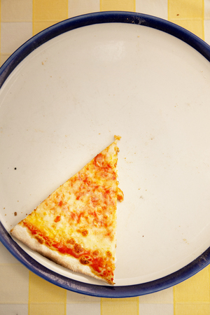 1 piece of pizza on a plateの写真素材