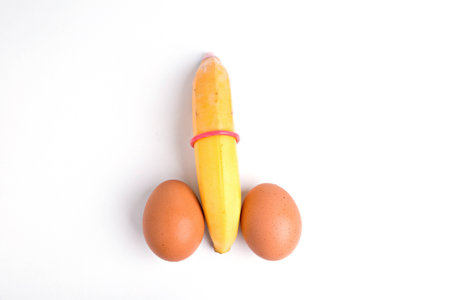 Yellow Banana with Condom Isolated on White Background の写真素材