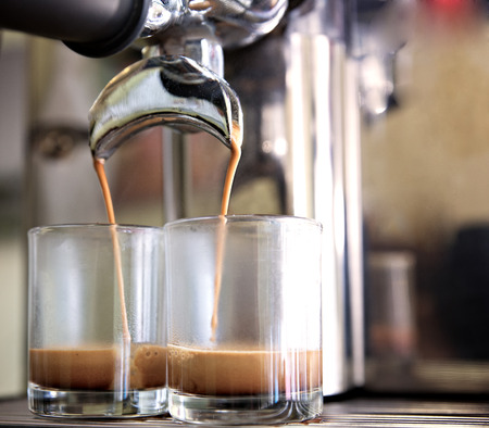 prepares espresso in his coffee shop; close-upの写真素材