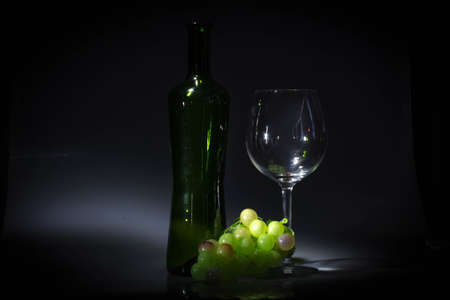 Wine glass and green grapesの写真素材