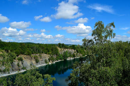 photos of a lake of a flooded slate quarry in the landscape of the foothills of the Jeseniky Mountains, Svobodne Hermanice, North Moravia, Czech Republicの写真素材