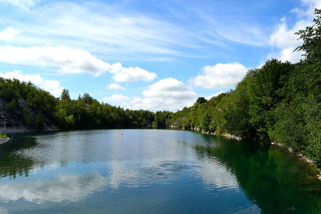 View of the calm surface of the flooded quarry inviting to rest and scuba diving, Svobodne Hermanice, northern Moravia, Czech Republicの写真素材