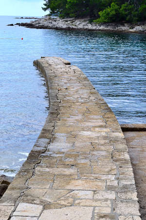 stone pier in a bay on the Istrian Adriatic coast, Rovinj, Croatiaの写真素材