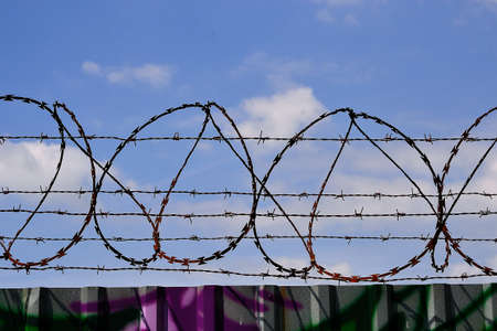barbed wire fence, two worlds of human civilizationの写真素材