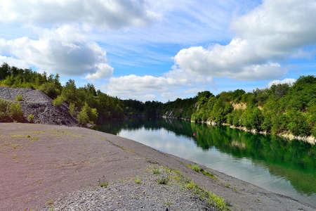 flooded slate quarry under summer sky, North Moravia, Czech Republicの写真素材