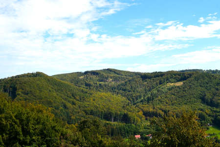 view from the castle viewpoint on the wooded hills in the foothills of the Beskydy Mountains with a summer sky on the horizonの写真素材