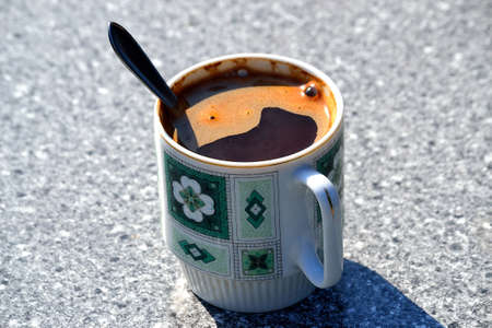 view of a table with hot black coffee as an encouragement to a new working dayの写真素材