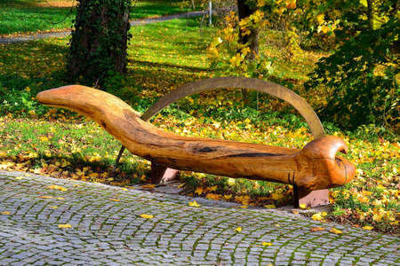 autumn photo of a wooden bench to relax in the park in an unconventional concept, Senov, North Moravia, Czech Republic, 10/30/2020の写真素材