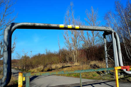 picture Industrial landscape, gas pipeline over a road closed by a metal gate, Karvina, North Moravia, Czech Republicの写真素材
