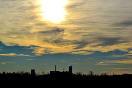 afternoon autumn sunset over the mining tower of a coal mine on the horizon of the industrial landscape, Karvina, Czech Republicの写真素材