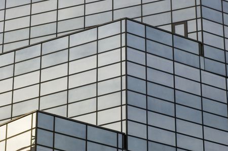 abstract reflecting windows on large business building