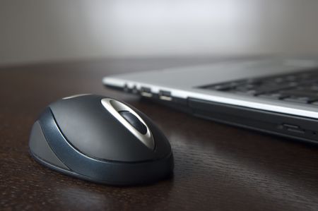 computer mouse close up with laptop in backgroundの写真素材