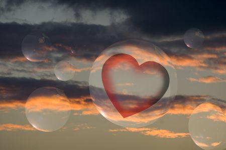 sphere with heart on a cloudy skyの写真素材